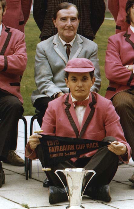 Robert Fukton holding the pennant (1970 Fairbairn Cup Highest Third Boat) with the Clare Novices' Regatta winners' trophy and Canon looking on benificently.